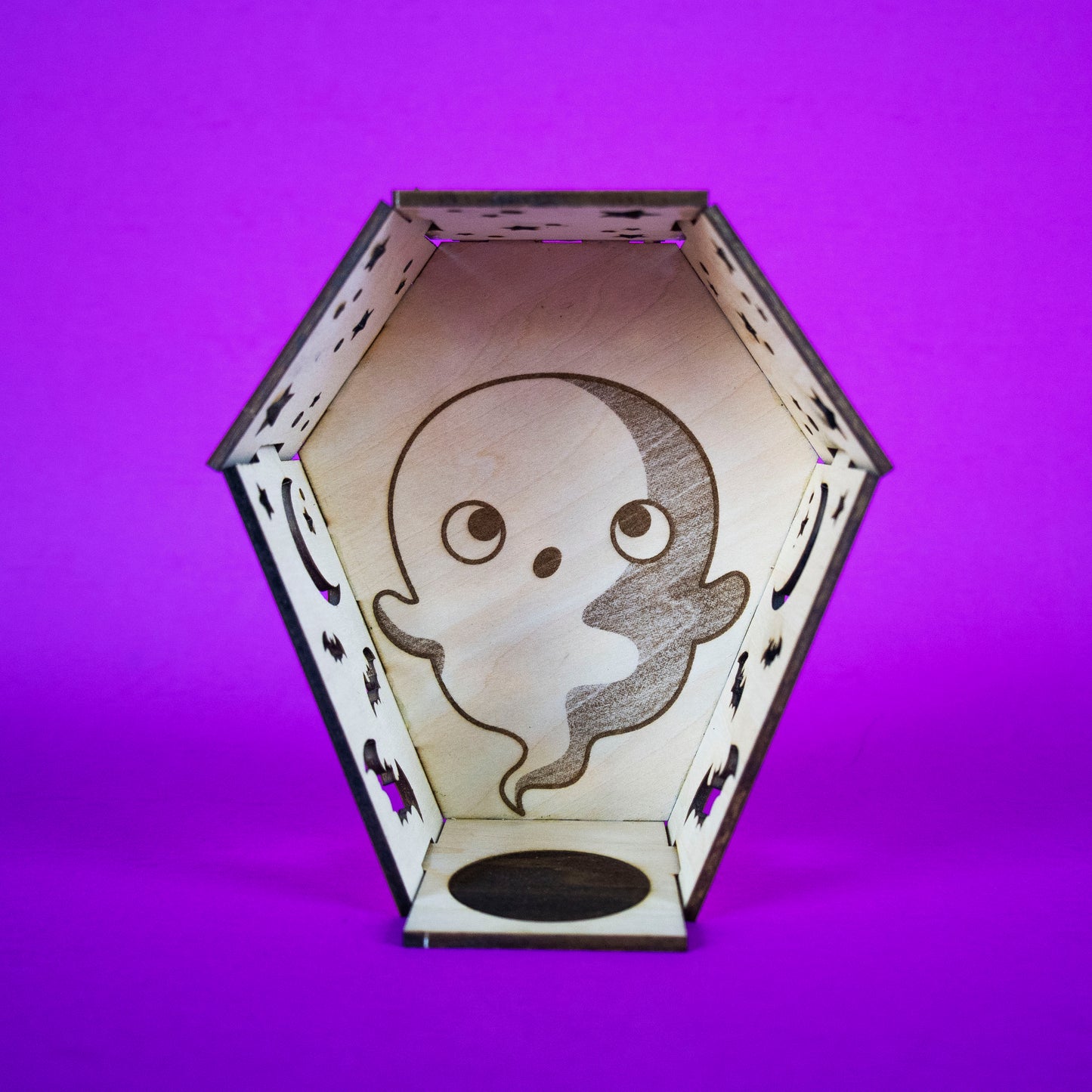 Ghost Coffin Candle Cutie built and front facing. A coffin made out of interlocking wood pieces with cut outs and space for a tea light candle.