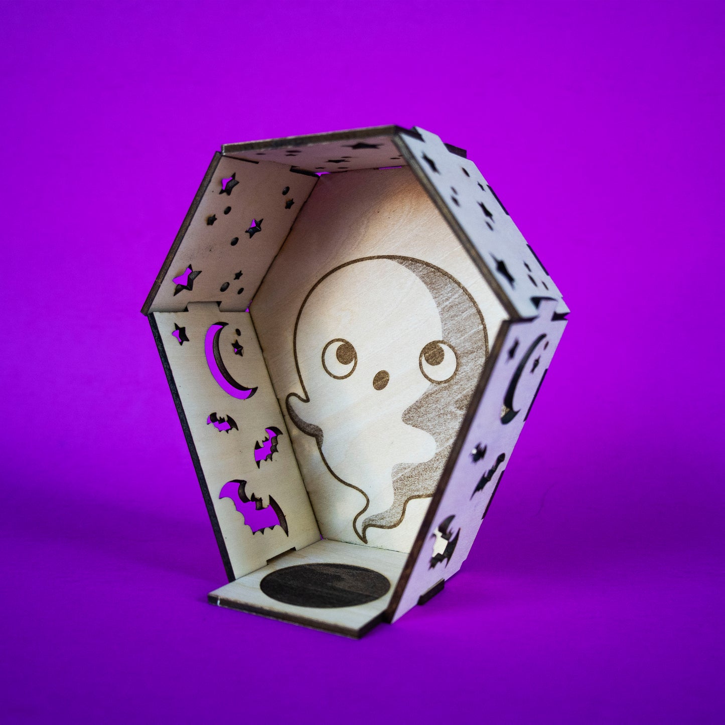 Ghost Coffin Candle Cutie built and angled. A coffin made out of interlocking wood pieces with cut outs and space for a tea light candle.