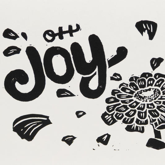 Close up of "Oh Joy" hand lettering with an illustration of a zinnia with petals floating around the text.
