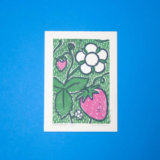 This 5x7 Strawberry Moon Linocut Print is a three-color print featuring a strawberry plant with leaves and a moonflower. 