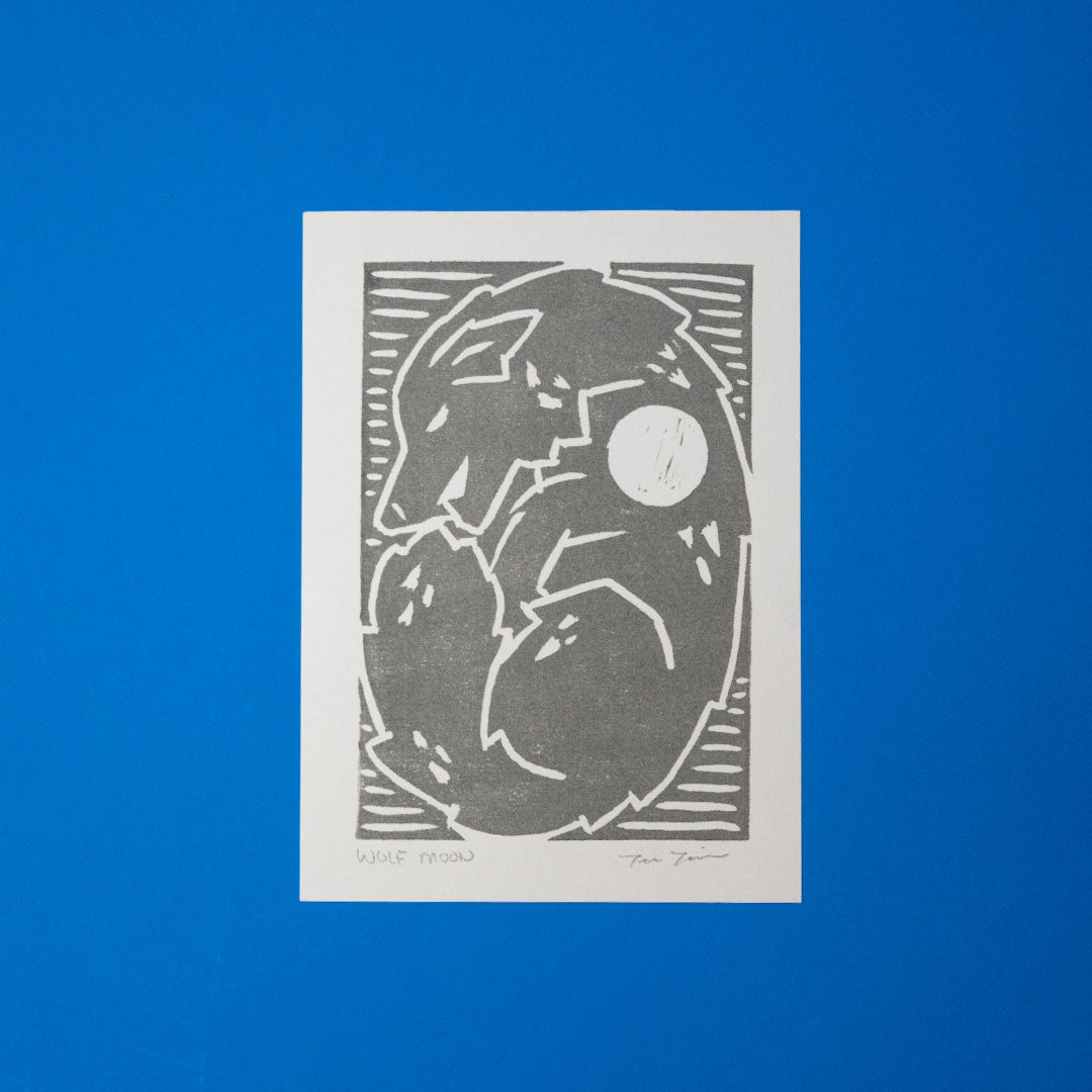 5x7 Wolf Moon Linocut Print features a wolf curled up all cozy with a moon on its shoulder