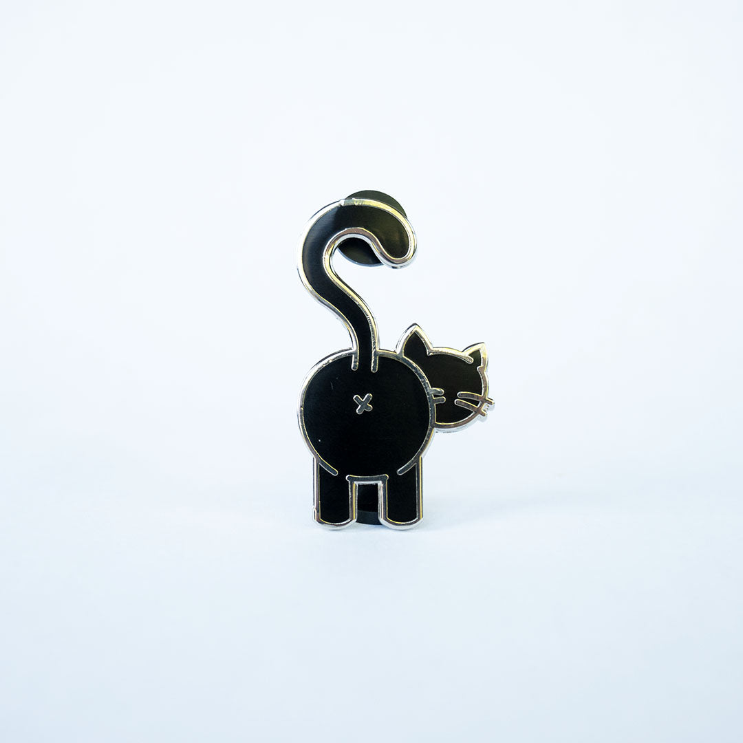Black cat butt pin with silver metal on white background.