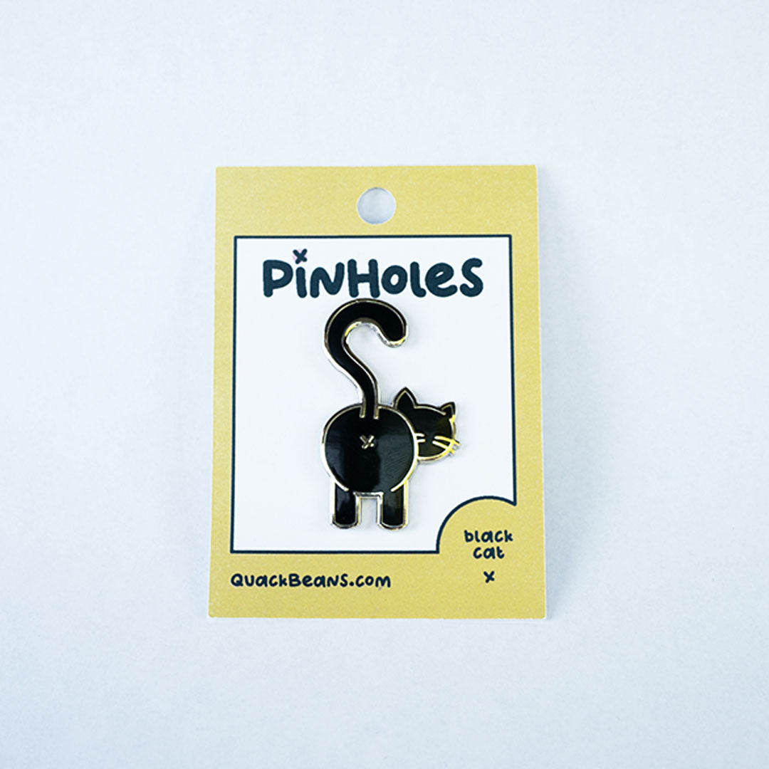 Black cat butt pin with silver metal on yellow Pinholes hang tag card.