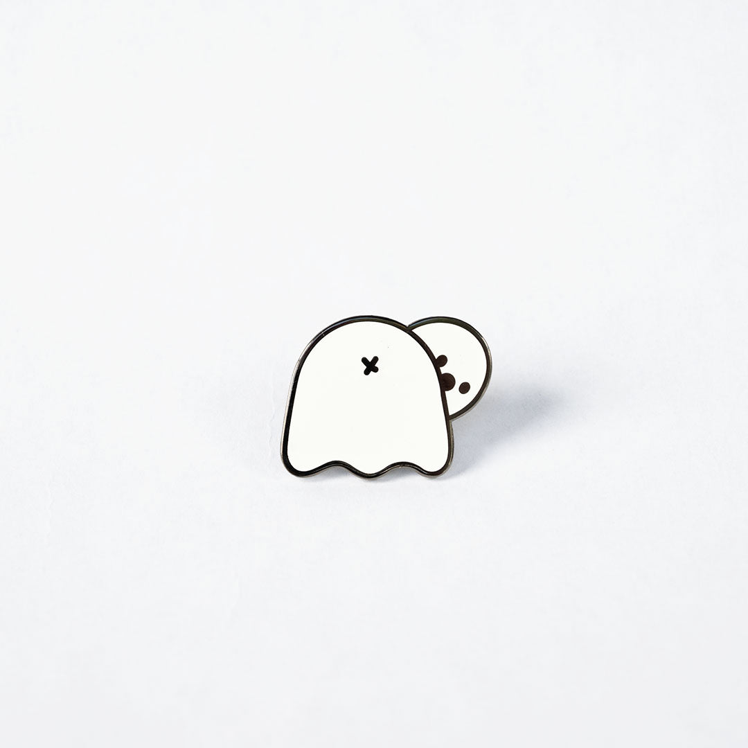 Glow in the dark ghost butt pin on white background.