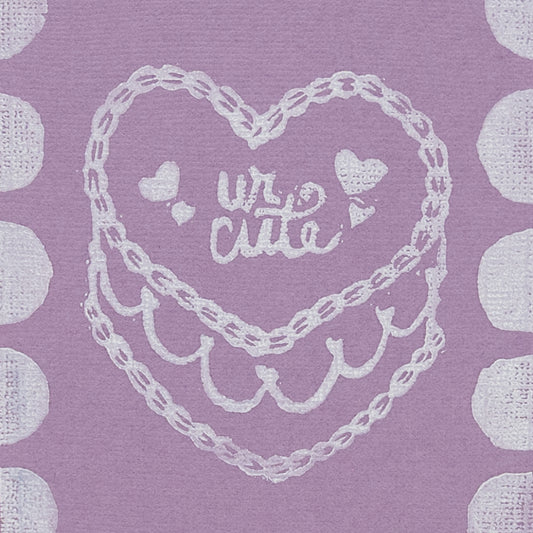 Close up image of "Ur Cute" cake illustration on purple background. 