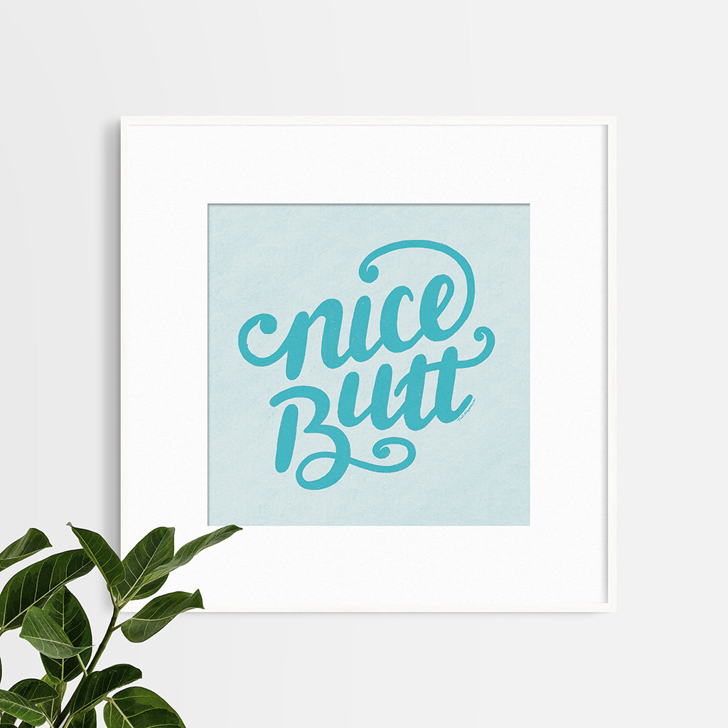 12"x12" art print with hand-lettered words "nice butt" in a frame with an 8"x8" mat opening.